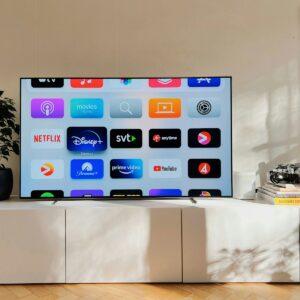 a flat screen tv sitting on top of a white cabinet